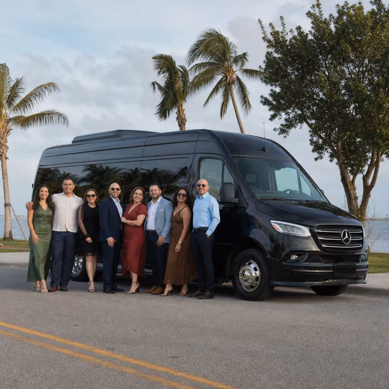 Group beside a Mercedes Sprinter limo from the Hialeah fleet