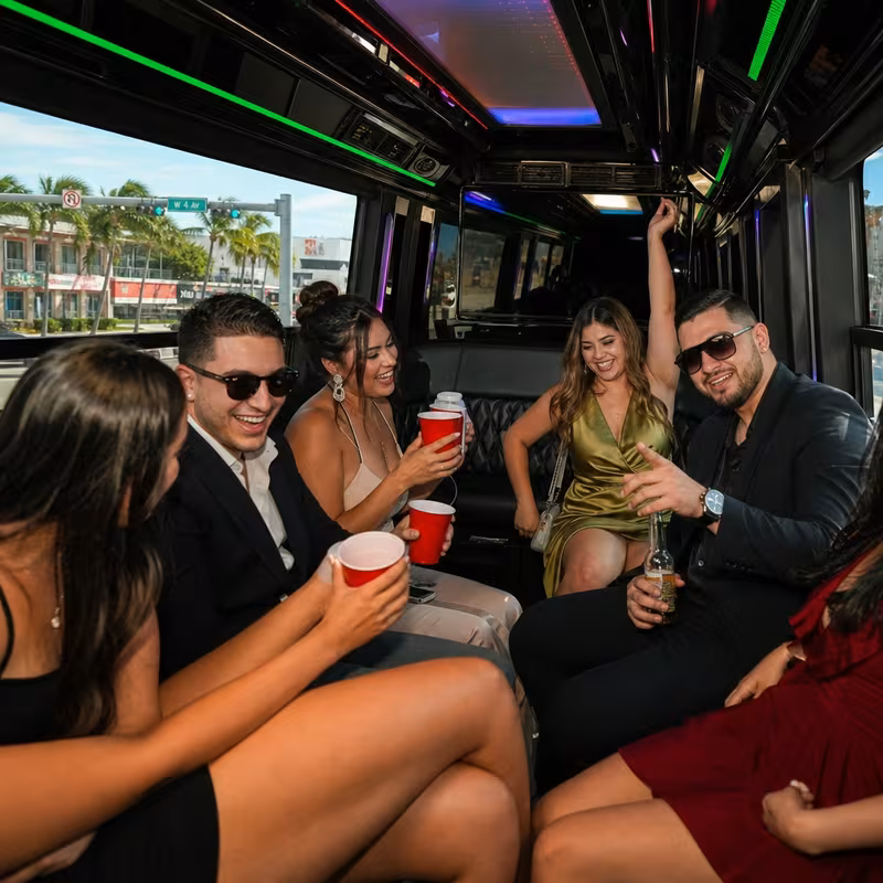 Party bus interior with wraparound leather seating and LED lighting in Hialeah