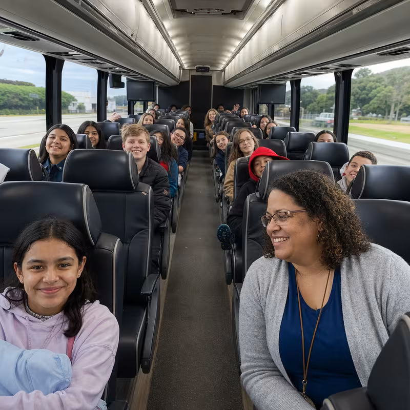 Group boarding a white charter bus for School Transportation transportation in Hialeah