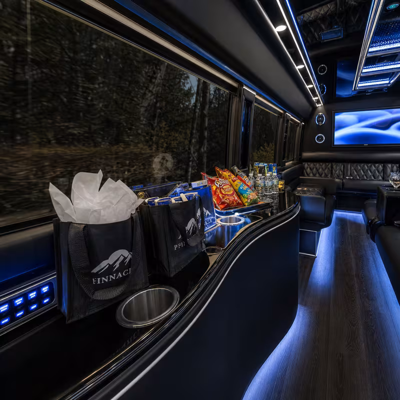 Party bus interior with wraparound leather seating and LED lighting in Hialeah